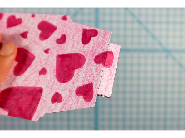 Fold the template on the dotted lines, with the holes facing each other as shown.