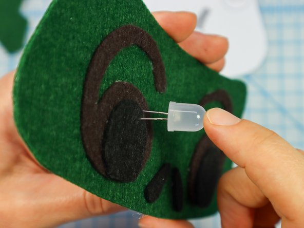 Insert each LED through the holes with the longer, positive leg in the top hole.