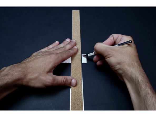 With proper supervision, use a ruler and an Exacto Knife to cut the two small corresponding slits shown in the photos at left. Make multiple passes with the blade and take care to only cut the length of line/slit on the template. You will thread two small sections of Maker Tape through these slits in the coming steps. 