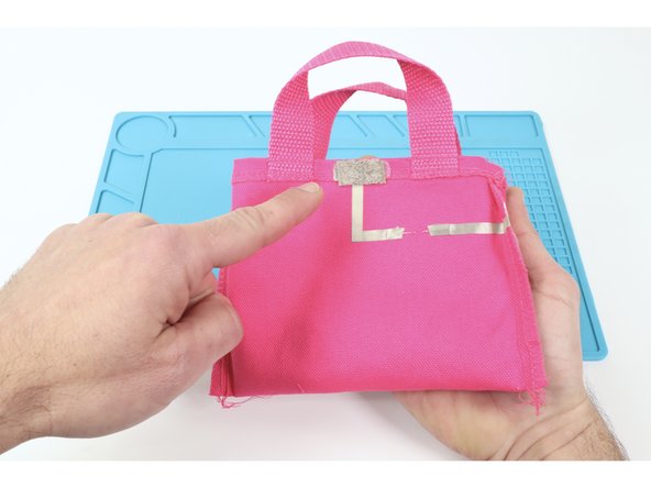 Using one of the three methods described in our Conductive Hook &amp; Loop guide (included at the end of the featured document), attach Conductive Hook on one side atop one of the upper Tape Loops and the Conductive Loop atop the remaining upper tape loop. 