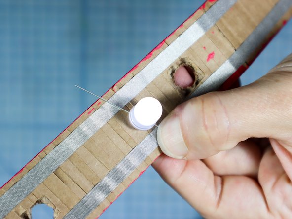 Test the LEDs position by spreading the LED's legs and connecting it between the two pieces of Maker Tape. If it lights up, you're good to go! If it doesn't light up, turn it around.