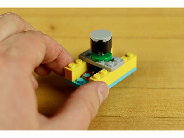 Just place your plate over the top of the switch so the axle makes contact with the button.