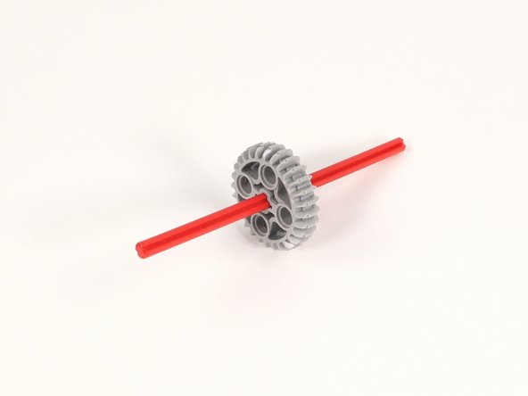 Add the large gear to the center of the 12-stud long axle.