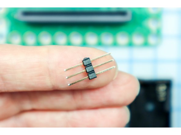 Plug the jumper wires into the NeoPixel string using three long headers as shown.