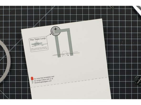 On the inside of the card, bend the LED legs down so they are flat against the surface of the paper.