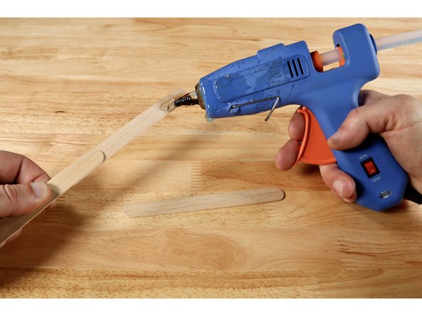 Attach 2-3 jumbo craft sticks by overlapping them and securing each overlapped section with either hot glue or wrapped (non-conductive) tape.  Overall length is only cosmetic and the rest of the instructions will remain the same regardless of how long you choose to make your wand.