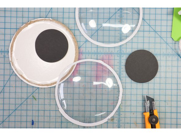 Use a box cutter to carefully remove the plastic from the back of the googly eyes.