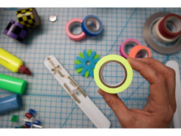 To embellish the band, wrap colorful tape around it, but don't cover the Xs!