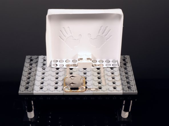 Place a single Crazy Circuits battery holder as shown. Take care to orient the part so that the white holes are where they are pictured in the circuit diagram sheet.