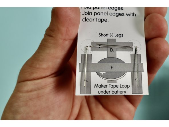 Flip over the tractor and bend the LED legs flat against the paper. Make sure to align the LED legs with the diagram on the back.