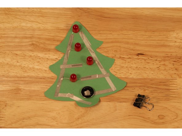 Add a small loop of Maker Tape to the tape on the tree where the battery will sit, and another loop to the top of the battery.