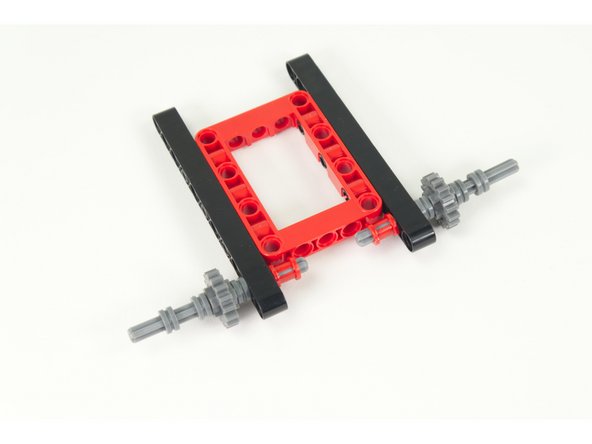 Place the large bushing on the end, inside the frame.