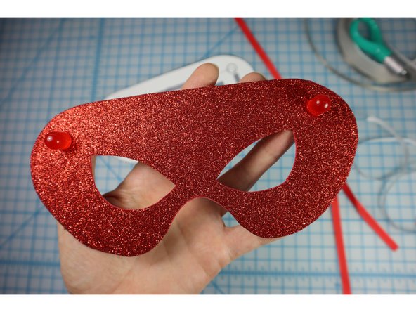 Add a piece of Maker Tape on top of the LED legs as shown.