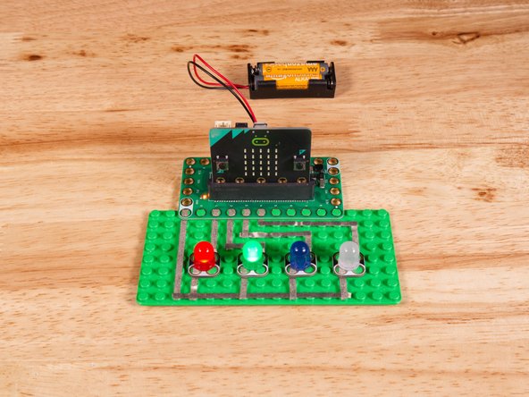 Connect the Negative (-) sides of the LEDs to a Ground (GND) hole on the Bit Board.
