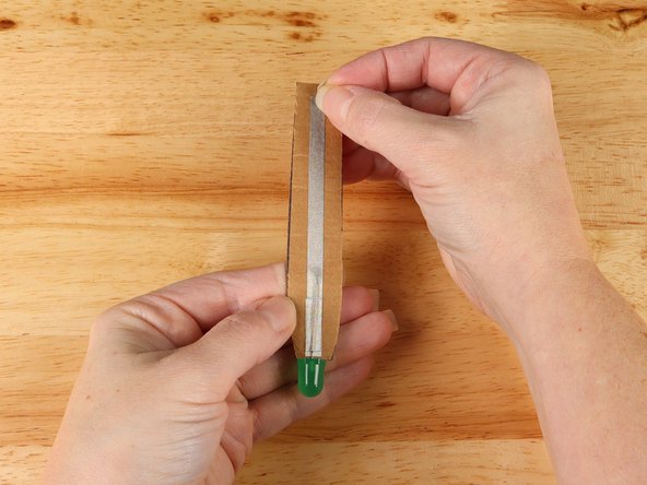 Add a long piece of Maker Tape to the front of the handle. The strip of Maker Tape should cover the LED and go all the way to the opposite end of the handle.