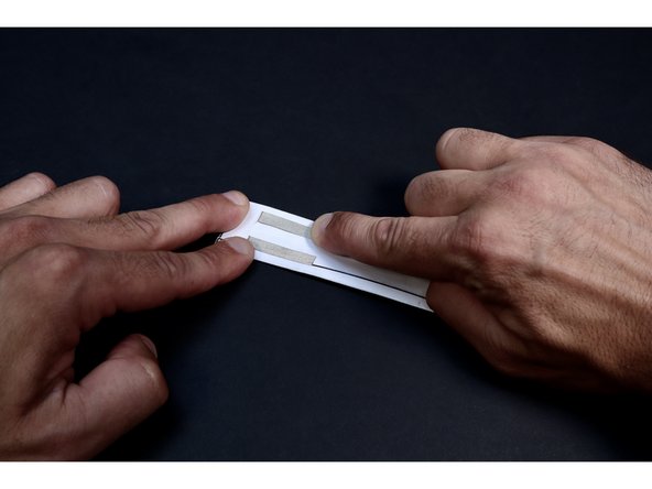 Note that the center fold creates two &quot;sections&quot; of template. Press each piece of tape down the middle of its' respective section away from the slit. DO NOT tape near/on top of the center fold.