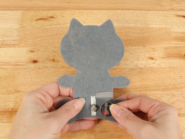 Make sure the Positive side of the Battery is facing upwards, with the Negative side stuck down to the tape.