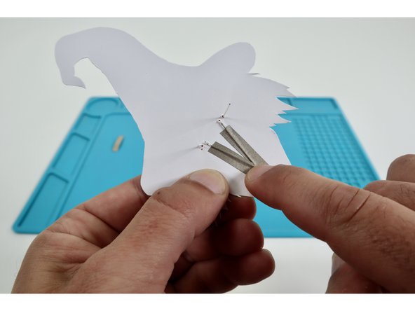 Peel and stick one of your remaining two Maker Tape pieces atop the remaining long leg and onto the paper below it.