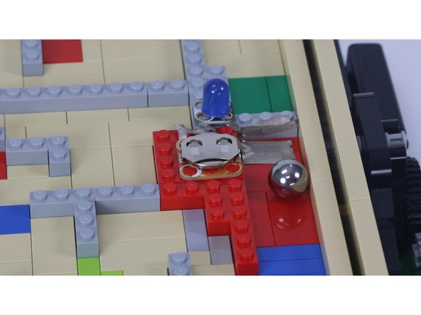 Here's a bonus feature you can add. While the maze came with a little LEGO soccer ball, we replaced it with a steel ball about the same size and then added a circuit we can trigger at the end.