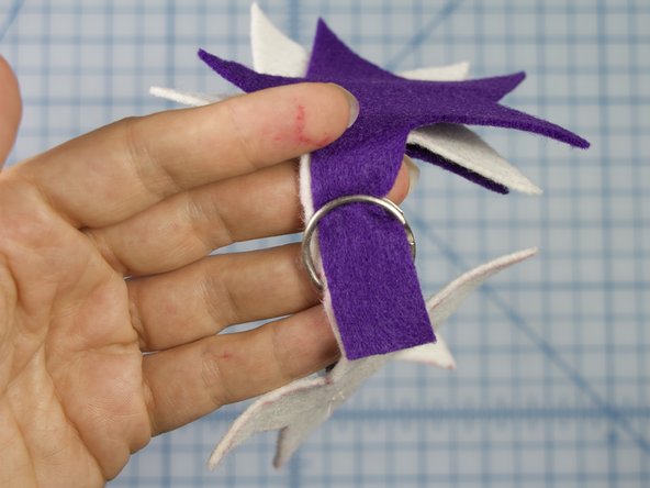 Attach the keychain around both pieces, just like you would add a key to the loop.