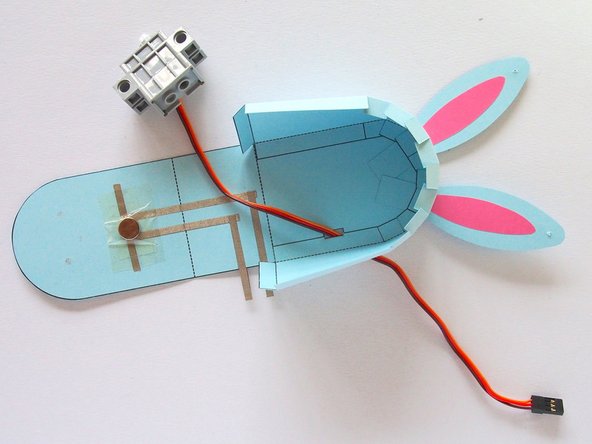 Thread the servo wire through the rectangular cutout in the body