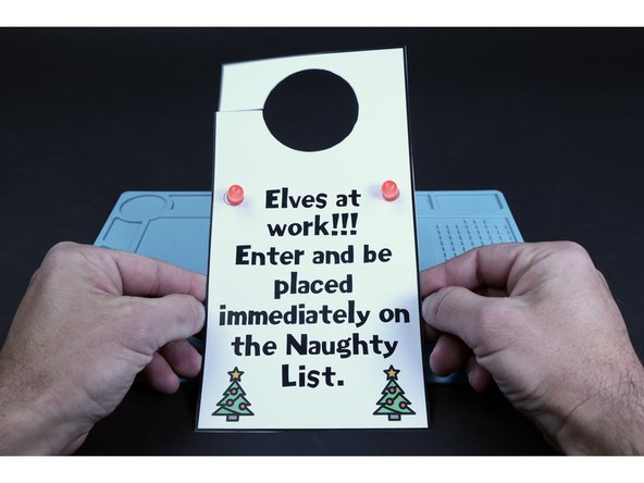 Peel and stick the final Maker Tape pathway where pictured. Sticking it to the top of the battery will turn the LEDs on the opposite side ON, while peeling it back will turn the LEDs OFF.