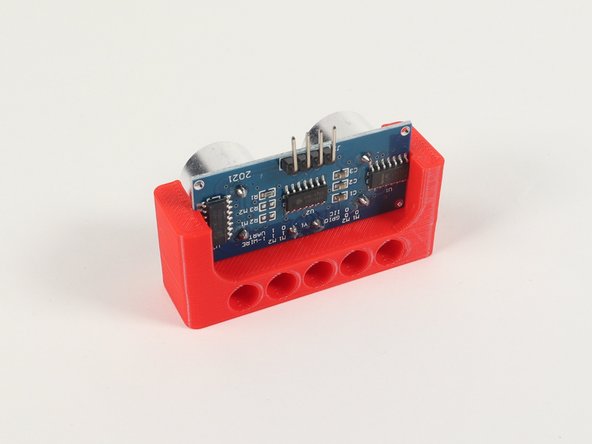 The Ultrasonic Distance Sensor slides into two slots on the Holder so the four connection pins on the Sensor are at the top so we can easily add jumper wires.