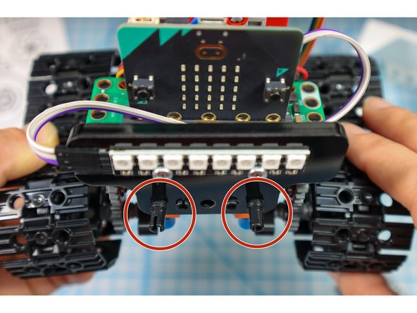 Add 2 pins to the front and 2 pins below the battery pack as shown. This will be where the paper body is attached.