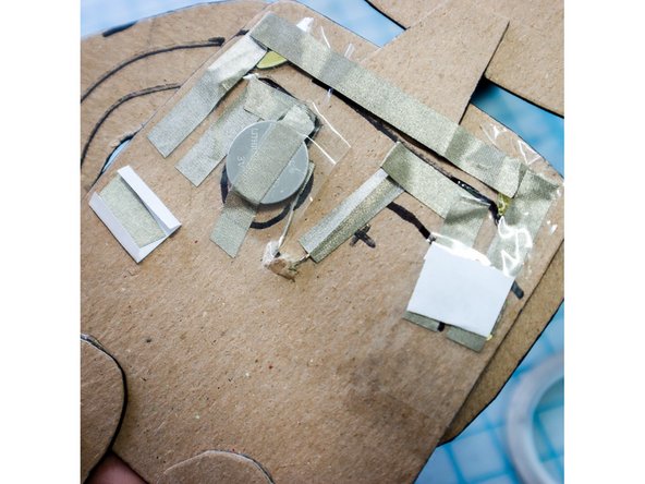 Make a paper flap by placing a piece of Maker Tape onto a small square of paper and folding over the edges as shown.