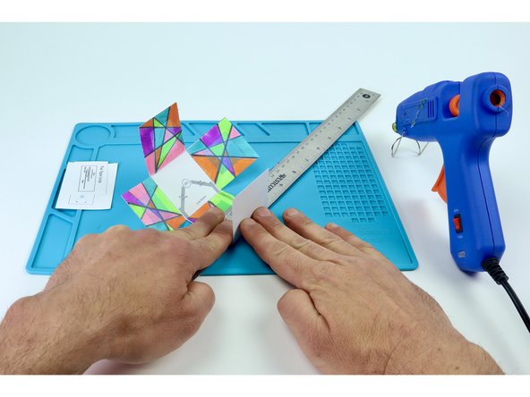After each of the 4 colored panels have been added, use a ruler as shown in photo 3 to help you fold the sides in preparation for final assembly.  It is easier to do this now without having added the circuitry.
