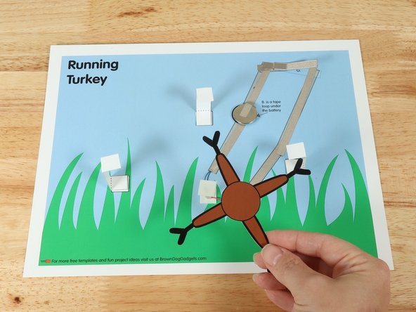 Add a square of double-sided foam tape onto the shaft of the motor, and then stick the legs to it.