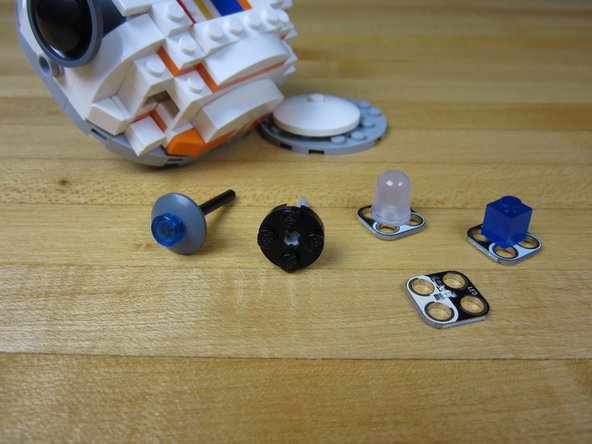 Use a small axle and attach it to a 2x2 round plate.