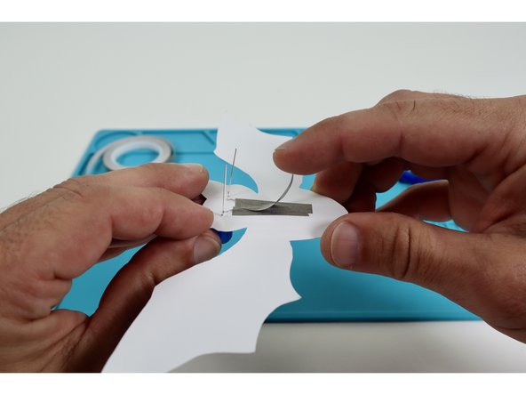 Peel and stick one of your remaining two Maker Tape pieces atop the remaining long leg and onto the paper below it.
