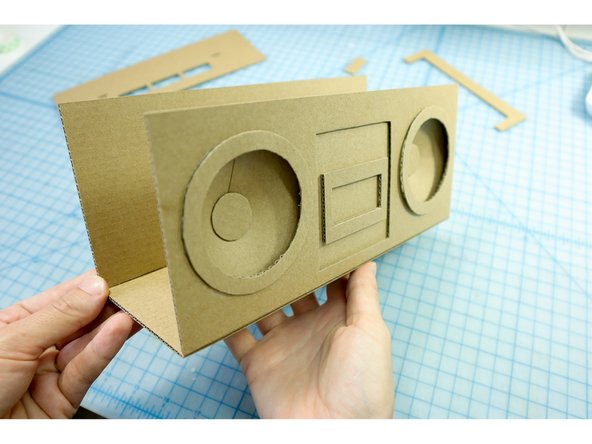 Glue the circles over the edge of the speakers.