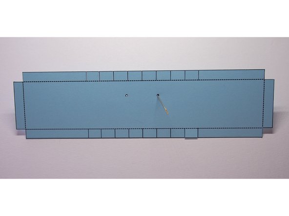 Use the sewing needle to poke holes in the paper where indicated on the template