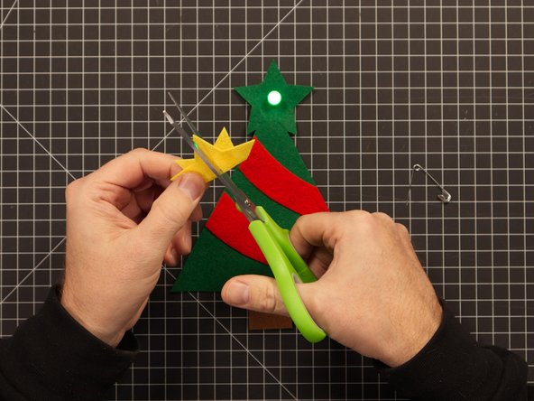 Let's add the star. To do so you'll need to cut a slit into it so it will fit over the LED.