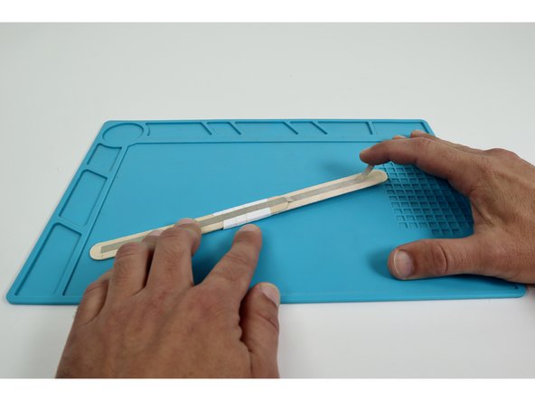 Place each of the two long Maker Tape pieces so they run end-to-end down the middle of each side of the wand handle.