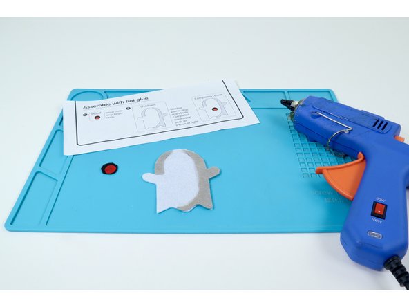 Use the assembly instructions found on the template sheet or these photos along with a hot glue gun to layer each piece correctly and form the final design.