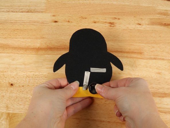 Make sure the Positive side of the Battery is facing upwards, with the Negative side stuck down to the tape.