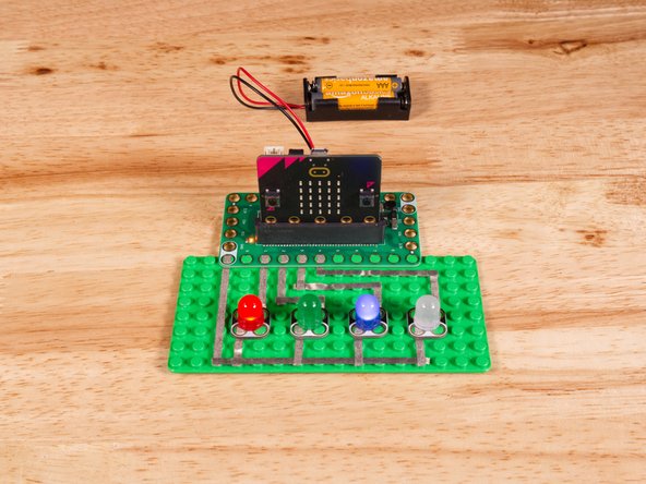 Connect the Negative (-) sides of the LEDs to a Ground (GND) hole on the Bit Board.