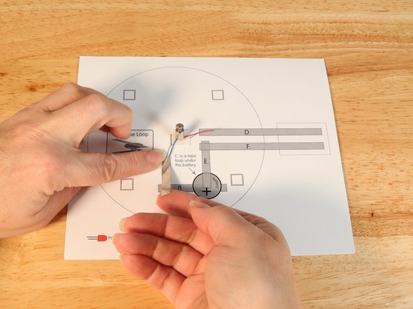 Using Maker Tape add Tape Path A. pressing it down atop the blue wire.