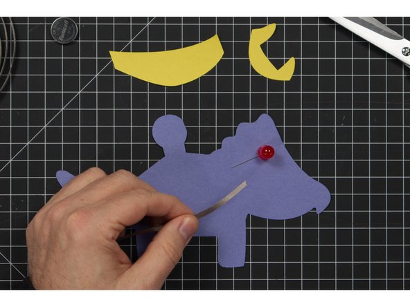 Run a piece of tape along the front of your Triceratops, covering the negative LED leg.