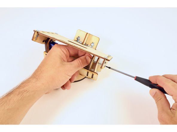 Use one (8-32) nut and your screwdriver to solidify this connection. Don't over tighten! This screw functions mostly as an axle that allows the plate above to swivel.
