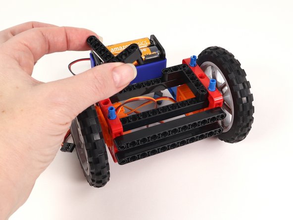 Remove both L-shaped beams and the 3 pins holding them in place.