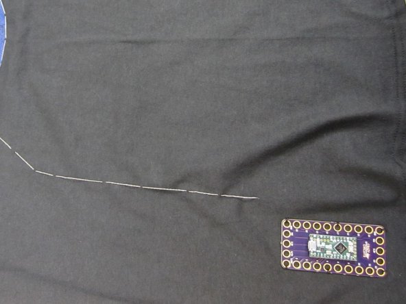 Start with the Ground pin on the Invention Board and sew your common ground.