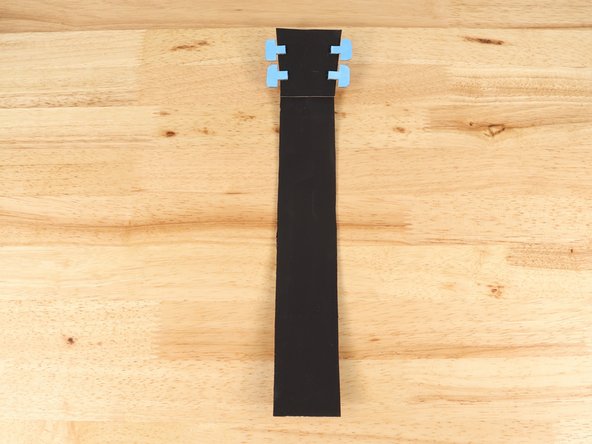 Using hot glue or another strong glue, attach the head to one end of the neck.