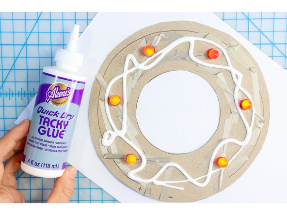 My second idea was to use pom-poms. I spread Tacky Glue all over the project with a paintbrush.