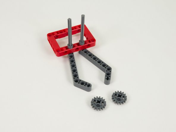 Press the two small gray gears down the axles so the are pressing against the half bushings.