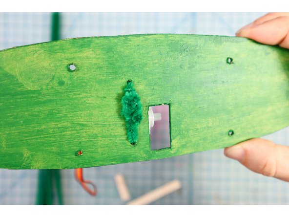 Use a pipe cleaner to attach the motor to the backplate as shown.