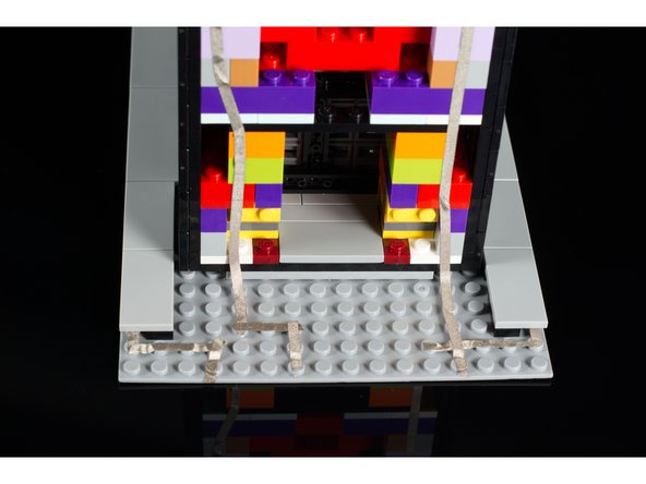 The Maker Tape that connects to the button should run all the way to the back of the baseplate where the micro:bit will attach.